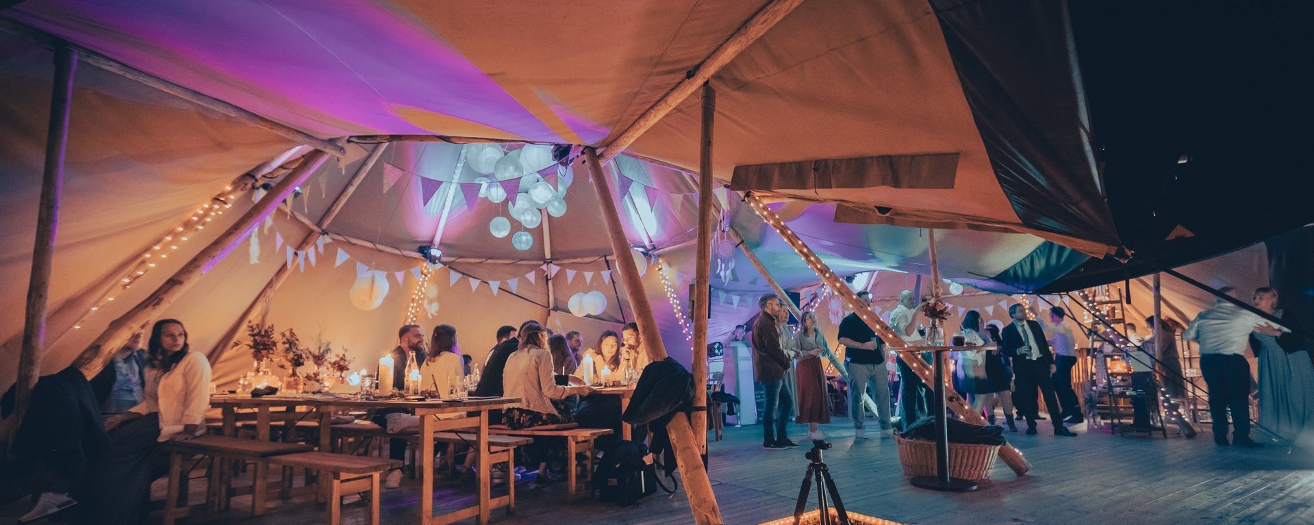 Blick ins Zelt einer Hochzeitsveranstaltung bei Nacht.